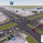 A busy intersection with traffic lights and multiple vehicles.